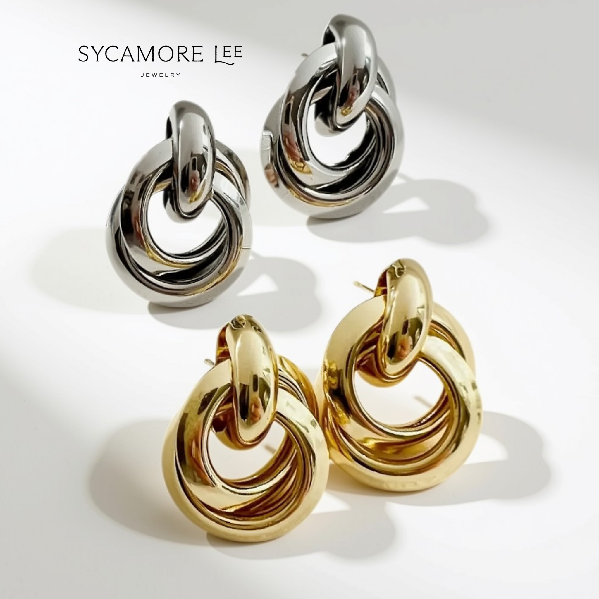 Sycamore Lee jewelry earrings with a polished, interlocking ring design, shown in both silver and gold finishes on a clean white background with soft shadows.