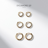 Six gold huggie hoop earrings arranged in two columns on a white background with soft diagonal shadows. The brand name 'SYCAMORE LEE JEWELRY' is printed at the top.