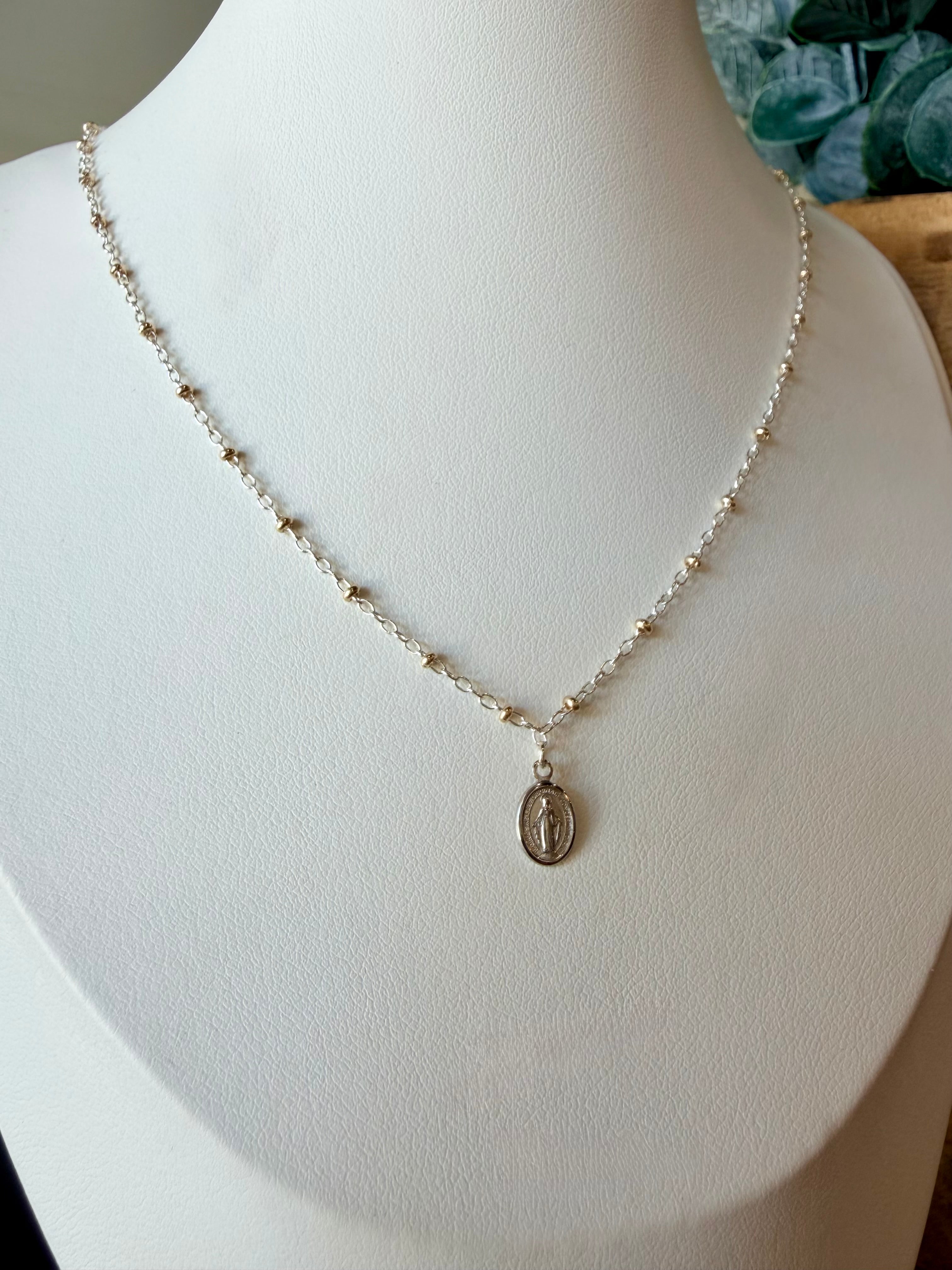 Miraculous Medals, known as a symbol of protection, guidance, and grace. Charm placed on a mixed metal delicate cable chain - Silver with gold beads.