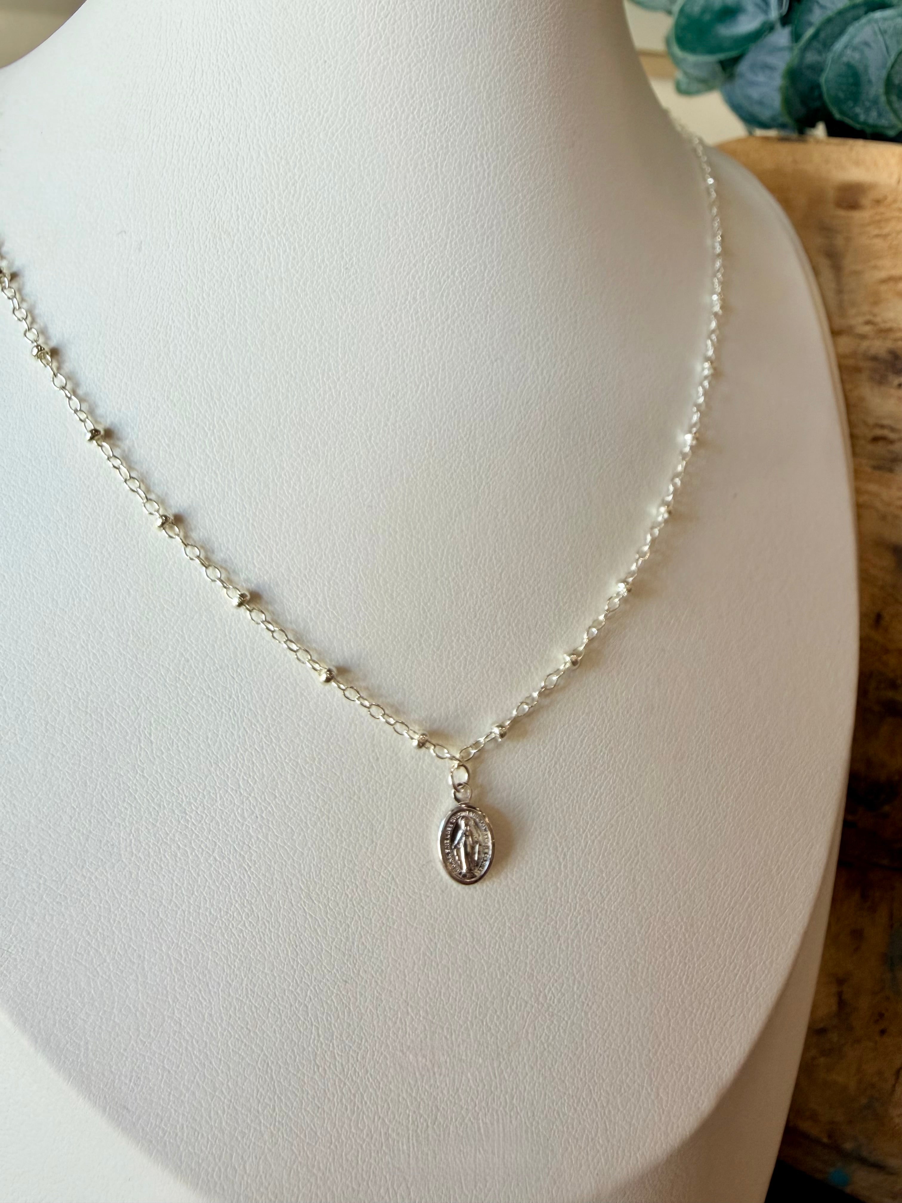 Miraculous Medals, known as a symbol of protection, guidance, and grace. Charm placed on a mixed metal delicate cable chain - Silver with silver beads.