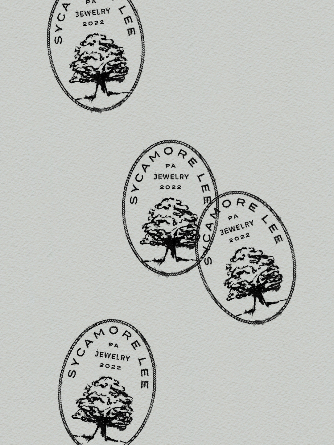 Repeating pattern of Sycamore Lee Jewelry logos on a light gray background