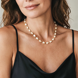 pearl necklace on a gold necklace with a women