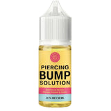 A bottle of Piercing Bump Solution by Body & Soul, featuring a yellow liquid inside a clear bottle with a white cap, set against a plain white background.